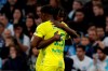 Nantes' Anthony Limbombe celebrates with teammate after he scored his side's opening goal during the French League One soccer match between Marseille and Nantes at the Stade Velodrome in Marseille, southern France, Sunday Feb. 22, 2020. (AP Photo/Daniel Cole)