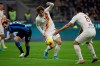 Roma's Nicolo Zaniolo, centre, vies for the ball with Inter Milan's Diego Godin, left, during a Serie A soccer match between Inter Milan and Roma, at the San Siro stadium in Milan, Italy, Friday, Dec.6, 2019. (AP Photo/Luca Bruno)