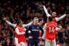 Arsenal's Alexandre Lacazette celebrates his goal after a video review with teammates during the Premier League soccer match between Arsenal and West Ham at the Emirates Stadium in London, Saturday, March 7, 2020.(AP Photo/Matt Dunham)