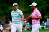 Hideki Matsuyama, of Japan, and Xander Schauffele, right, congratulate themselves after their eagles on the 15th hole during the third round of the Masters golf tournament on Saturday, April 10, 2021, in Augusta, Ga. (AP Photo/Matt Slocum)