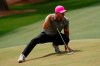 Brooks Koepka stretches to line up a putt on the 14th green during the first round of the Masters golf tournament on Thursday, April 8, 2021, in Augusta, Ga. (AP Photo/David J. Phillip)
