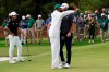 Dustin Johnson is hugged by his caddie Austin Johnson after winning the Masters golf tournament Sunday, Nov. 15, 2020, in Augusta, Ga. (AP Photo/David J. Phillip)