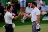 Rory McIlroy, of Northern Ireland, bumps fists with Jon Rahm, of Spain, on the 18th green during the second round of the Masters golf tournament on Friday, April 9, 2021, in Augusta, Ga. (AP Photo/Matt Slocum)
