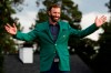 Masters golf champion Dustin Johnson shows off his green jacket after his victory Sunday, Nov. 15, 2020, in Augusta, Ga. (AP Photo/Matt Slocum)