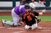 San Francisco Giants' Mike Yastrzemski (5) scores ahead of Colorado Rockies catcher Elias Diaz during the first inning of a spring training baseball game Friday, March 12, 2021, in Scottsdale, Ariz. Colorado Rockies shortstop Trevor Story committed a throwing error. (AP Photo/Ashley Landis)