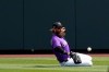 Colorado Rockies right fielder Charlie Blackmon slides to field a fly ball hit by Los Angeles Dodgers' Justin Turner during the first inning of a spring training baseball game Monday, March 15, 2021, in Scottdale, Ariz. (AP Photo/Ashley Landis)