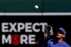 Texas Rangers right fielder Ronald Guzman (11) catches a fly ball hit by Colorado Rockies' Elias Diaz during the second inning of a spring training baseball game Monday, March 22, 2021, in Scottsdale, Ariz. (AP Photo/Ashley Landis)