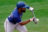 Texas Rangers' Deline DeShields bunt grounds out during the seventh inning of a spring training baseball game against the Milwaukee Brewers Saturday, March 13, 2021, in Phoenix. (AP Photo/Ashley Landis)