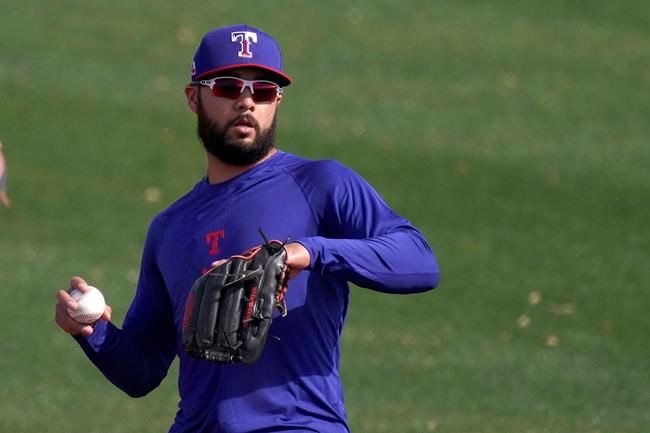 Texas Rangers' Isiah Kiner-Falefa throws during spring training baseball practice Friday, Feb. 26, 2021, in Surprise, Ariz. (AP Photo/Charlie Riedel)