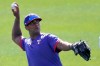 Texas Rangers' Khris Davis throws during spring training baseball practice, Friday, Feb. 26, 2021, in Surprise, Ariz. (AP Photo/Charlie Riedel)