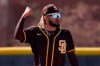 San Diego Padres' Fernando Tatis Jr. reacts after making a catch during spring training baseball practice Saturday, Feb. 27, 2021, in Peoria, Ariz. (AP Photo/Charlie Riedel)