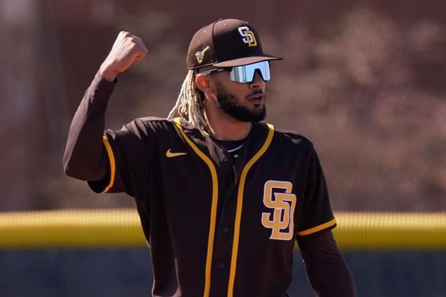 San Diego Padres' Fernando Tatis Jr. reacts after making a catch during spring training baseball practice Saturday, Feb. 27, 2021, in Peoria, Ariz. (AP Photo/Charlie Riedel)