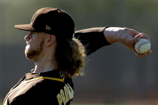 San Diego Padres pitcher Chris Paddack throws during spring training baseball practice Saturday, Feb. 15, 2020, in Peoria, Ariz. (AP Photo/Charlie Riedel)