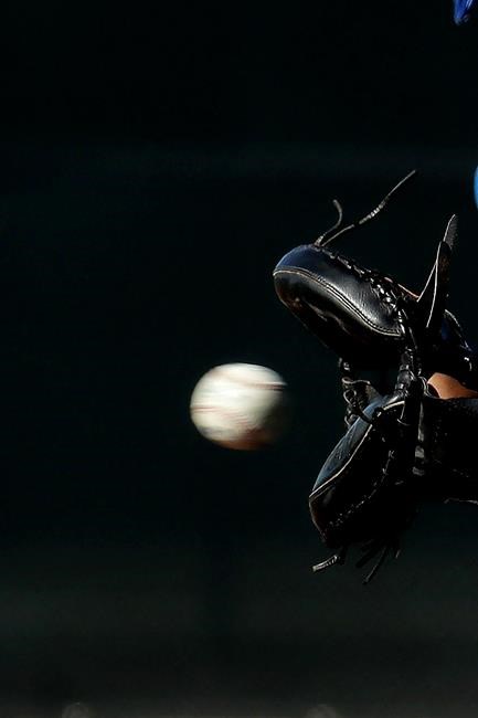 Kansas City Royals catcher Salvador Perez (13) catches a ball during spring training baseball practice Wednesday, Feb. 12, 2020, in Surprise, Ariz. (AP Photo/Charlie Riedel)