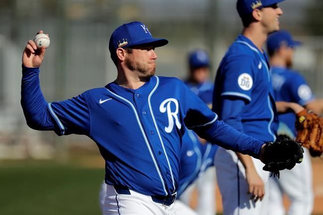 Kansas City Royals pitcher Greg Holland throws during spring training baseball practice Wednesday, Feb. 12, 2020, in Surprise, Ariz. (AP Photo/Charlie Riedel)