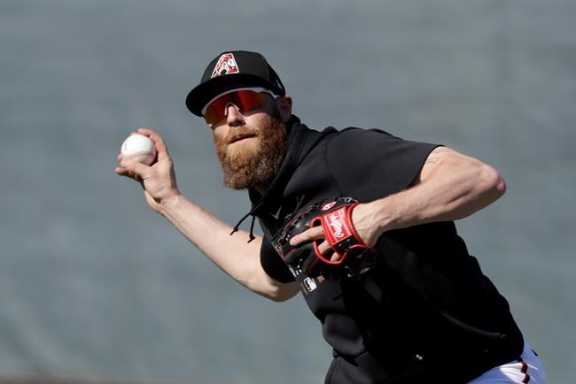 Arizona Diamondbacks' Archie Bradley throws during spring training baseball practice, Sunday, Feb. 16, 2020, in Scottsdale, Ariz. (AP Photo/Darron Cummings)