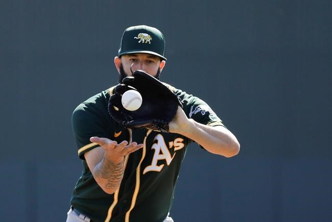 Oakland Athletics' Mike Fiers runs a drill during spring training baseball practice, Thursday, Feb. 13, 2020, in Mesa, Ariz. (AP Photo/Darron Cummings)