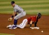 Colorado Rockies shortstop Trevor Story, left, looks for the ball after Arizona Diamondbacks' Wyatt Mathisen dove back into second base during the fourth inning of a baseball game Sunday, Sept. 27, 2020, in Phoenix. (AP Photo/Darryl Webb)