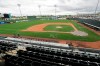 A broadcast crew finishes-up near the Kansas City Royals' dugout in an otherwise empty ballpark after the cancellation of a spring training baseball game between the Royals and the Seattle Mariners Thursday, March 12, 2020, in Surprise, Ariz. Major League Baseball is delaying the start of its season by at least two weeks because of the coronavirus outbreak and has suspended the rest of its spring training game schedule. (AP Photo/Elaine Thompson)