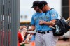 Seattle Mariners' Connor Lien, left, and Mitch Nay stop to sign autographs before a spring training baseball game against the Los Angeles Angels on Tuesday, March 10, 2020, in Peoria, Ariz. (AP Photo/Elaine Thompson)