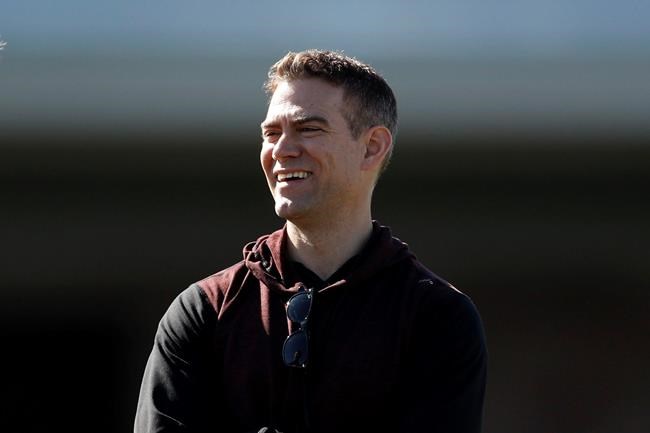 Chicago Cubs president of baseball operations Theo Epstein looks on during a spring training baseball workout Wednesday, Feb. 12, 2020, in Mesa, Ariz. (AP Photo/Gregory Bull)