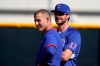 Chicago Cubs' Anthony Rizzo, left, and Kris Bryant stand on the field during a spring training baseball workout in Mesa, Ariz., Monday, Feb. 22, 2021. (AP Photo/Jae C. Hong)