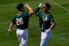 Oakland Athletics' Matt Olson greets Matt Chapman (26) after hitting a solo home run against the Los Angeles Angels during the third inning of a spring training baseball game, Friday, March 5, 2021, in Mesa, Ariz. (AP Photo/Matt York)