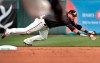 San Francisco Giants' Brandon Crawford can't reach a base hit by Chicago Cubs' Wilson Contreras during the first inning of a spring training baseball game Tuesday, March 10, 2020, in Scottsdale, Ariz. (AP Photo/Matt York)