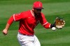 Los Angeles Angels' David Fletcher fields a base hit by Oakland Athletics' Elvis Andrus during the third inning of a spring training baseball game, Saturday, March 20, 2021, in Tempe, Ariz. (AP Photo/Matt York)