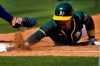 Oakland Athletics' Tony Kemp dives back safely on a pick-off attempt abasing the Chicago Cubs during the second inning of a spring training baseball game, Friday, March 19, 2021, in Mesa, Ariz. (AP Photo/Matt York)