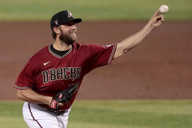 Arizona Diamondbacks pitcher Madison Bumgarner throws during an intrasquad baseball game at practice Tuesday, July 14, 2020, in Phoenix. (AP Photo/Matt York)