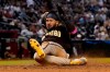 San Diego Padres' Fernando Tatis Jr. scores on a ground out hit by Manny Machado during the sixth inning of a baseball game against the Arizona Diamondbacks, Tuesday, April 27, 2021, in Phoenix. (AP Photo/Matt York)