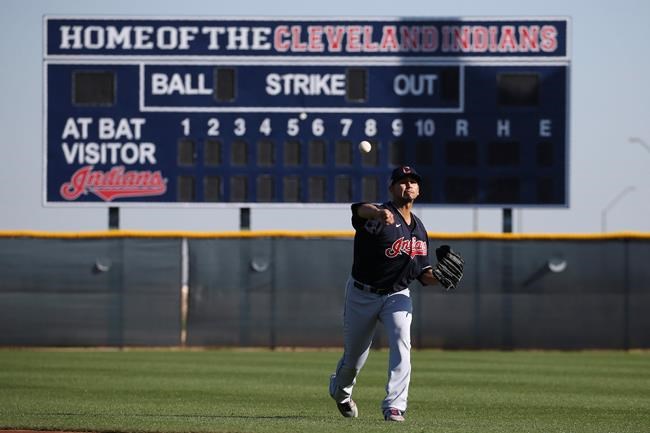 Cleveland Indians starting pitcher Carlos Carrasco warms up during spring training baseball workouts for pitchers and catchers Thursday, Feb. 13, 2020, in Avondale, Ariz. (AP Photo/Ross D. Franklin)