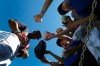 Cleveland Indians' Francisco Lindor, left, signs autographs for fans, signing gloves, baseballs, hats and uniforms prior to the team's spring training baseball game against the Chicago Cubs on Saturday, March 7, 2020, in Goodyear, Ariz. Lindor and many Indians players signed autographs for fans Saturday, even as the MLB set new policies in place as a precaution due to the coronavirus. (AP Photo/Ross D. Franklin)