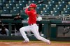 Cincinnati Reds' Shogo Akiyama, of Japan, follows through on his swing as he hits an infield grounder against the Chicago White Sox during the first inning of a spring training baseball game Thursday, March 11, 2021, in Goodyear, Ariz. Reds' Akiyama was out at first base on the play. (AP Photo/Ross D. Franklin)