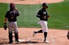 Chicago White Sox's Eloy Jimenez, right, scores a run as Cleveland Indians catcher Austin Hedges pauses at home plate during the first inning of a spring training baseball game Saturday, March 20, 2021, in Phoenix. (AP Photo/Ross D. Franklin)