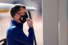 Chicago White Sox general manager Rick Hahn adjusts his face covering as he watches players during baseball spring training Wednesday, Feb. 24, 2021, in Phoenix. (AP Photo/Ross D. Franklin)