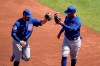 Chicago Cubs shortstop Eric Sogard, left, is congratulated by Cubs third baseman Ildemaro Vargas after Sogard's inning ending out against the Cleveland Indians during the second inning of a spring training baseball game Thursday, March 18, 2021, in Goodyear, Ariz. (AP Photo/Ross D. Franklin)