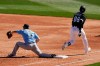 Chicago White Sox's Luis Robert (88) beats out an infield single as Seattle Mariners first baseman Sam Travis (13) makes a late catch during the third inning of a spring training baseball game Friday, March 5, 2021, in Phoenix. (AP Photo/Ross D. Franklin)