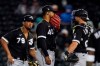 Chicago White Sox starting pitcher Reynaldo Lopez (40) gets a visit from White Sox catcher Jonathan Lucroy, right, and first baseman Jose Abreu (79) during the third inning of a spring training baseball game against the Cincinnati Reds Thursday, March 11, 2021, in Goodyear, Ariz. (AP Photo/Ross D. Franklin)