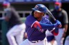 Texas Rangers' Willie Calhoun bats in the fourth inning of a spring training baseball game against the San Diego Padres, Thursday, March 4, 2021, in Surprise, Ariz. Calhoun, who got hit in the face by a fastball in a 2020 spring training game says he no longer feels like flinching or bailing out on breaking pitches. (AP Photo/Sue Ogrocki)