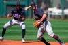 Cleveland Indians third baseman Mike Freeman, right, throws to first base for the out on a ground ball hit by Texas Rangers' Isiah Kiner-Falefa during the first inning of a spring training baseball game Tuesday, March 9, 2021, in Surprise, Ariz. (AP Photo/Sue Ogrocki)