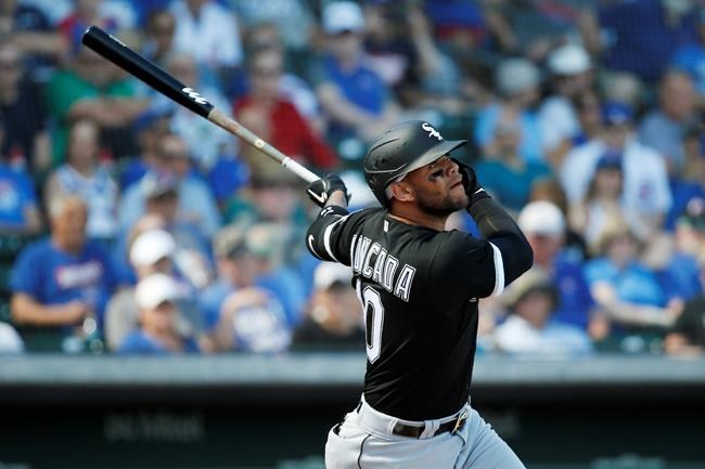 Chicago White Sox third baseman Yoan Moncada (10) watches his single in the first inning of a spring training baseball game against the Chicago Cubs, Friday, March 6, 2020, in Mesa, Ariz. (AP Photo/Sue Ogrocki)
