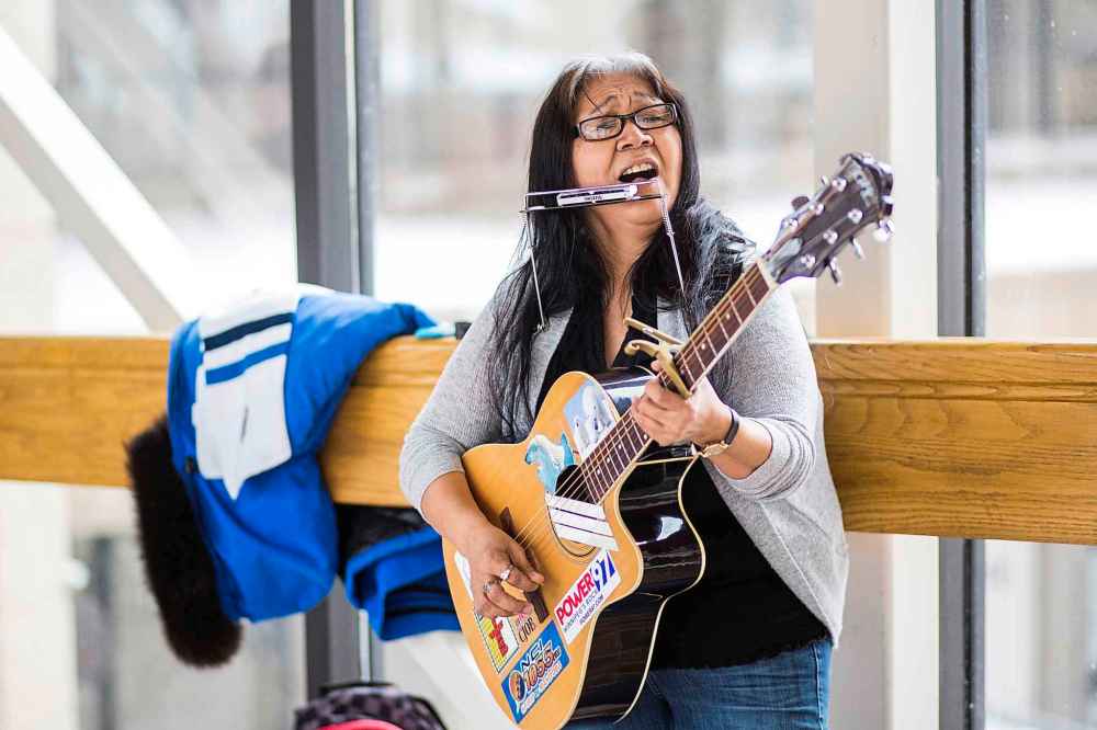 Issaluk’s guitar is festooned with so many stickers you would swear the guitar is half made from them. (Mikaela MacKenzie / Winnipeg Free Press)