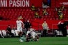 A Betis player, center, duels for the ball against Sevilla players during their Spanish La Liga soccer match in Seville, Spain, Thursday, June 11, 2020. With virtual crowds, daily matches and lots of testing for the coronavirus, soccer is coming back to Spain. The Spanish league resumes this week more than three months after it was suspended because of the pandemic, becoming the second top league to restart in Europe. The Bundesliga was first. The Premier League and the Italian league should be next in the coming weeks. (AP Photo)