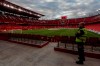 A steward watches from the empty stands before the start of the Spanish La Liga soccer match between Sevilla and Betis in Seville, Spain, Thursday, June 11, 2020. With virtual crowds, daily matches and lots of testing for the coronavirus, soccer is coming back to Spain. The Spanish league resumes this week more than three months after it was suspended because of the pandemic, becoming the second top league to restart in Europe. The Bundesliga was first. The Premier League and the Italian league should be next in the coming weeks. (AP Photo)