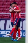 Atletico Madrid's Angel Correa, right, is congratulated after scoring the opening goal during the Spanish La Liga soccer match between Atletico Madrid and Eibar at Wanda Metropolitano stadium in Madrid, Spain, Sunday, April 18, 2021. (AP Photo/Bernat Armangue)