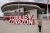 A woman takes a snapshot in front Atletico Madrid's Wanda Metropolitano stadium in Madrid, Spain, Tuesday, April 20, 2021. A group of 12 elite English, Spanish and Italian clubs dramatically split European soccer on Sunday by announcing the formation of a largely-closed Super League. The Super League's founding chairman Florentino Perez on Tuesday, April 20, 2021 says the competition is being created to save soccer for everyone and not to make the rich clubs richer. The Real Madrid president says it's 