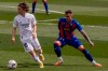 Real Madrid's Luka Modric, left, duels for the ball with Eibar's Damian Kadzior during the Spanish La Liga soccer match between Real Madrid and Eibar at the Alfredo di Stefano stadium in Madrid, Spain, Saturday, April 3, 2021. (AP Photo/Bernat Armangue)
