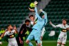 Real Madrid's goalkeeper Thibaut Courtois and Elche's Lucas Boye, center, jump for the ball during the Spanish La Liga soccer match between Real Madrid and Elche CF at the Manuel Martinez Valero stadium in Elche, Spain, Wednesday, Dec. 30, 2020. (AP Photo/Jose Breton)